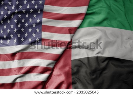 big waving colorful flag of united states of america and national flag of united arab emirates . macro