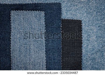 Denim blue jeans fabric flaps background. Tailor denim Samples. Destroyed torn denim blue jeans patches. Denim swatches for tailoring. Many fragments of jean cloth. Small sample of jeans fabric.