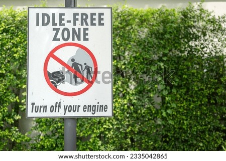 "Idle-Free zone" symbol banner at public vehicle parking lot, the information for all cars must be turn-off the engine to reduce the environmental pollution. Transportation symbol object.