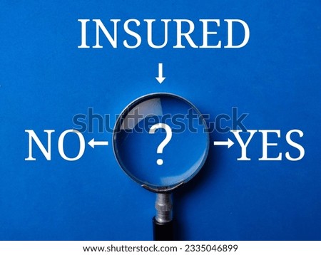 Magnifying glass with the word INSURED NO YES on a blue background