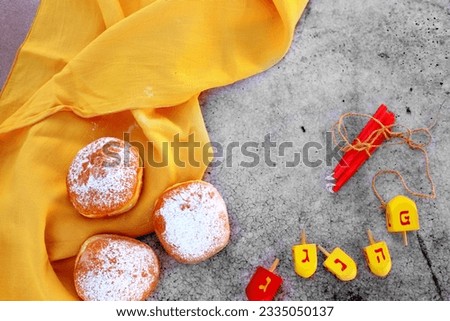Religion image of jewish holiday Hanukkah background with spinning tops, Donuts (sufganyot) and candles. topshot photogrphy
