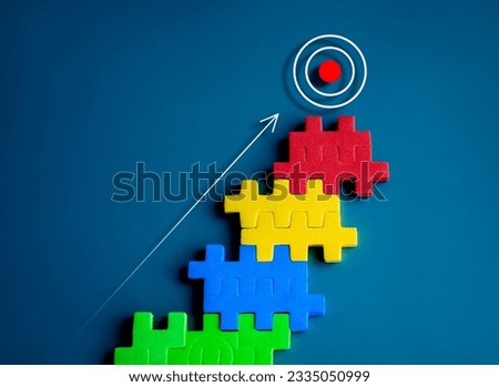 The ultimate goal, Target icon on top of colorful puzzle blocks as bar graph chart steps on blue background, minimal style. Business growth process, winner, opportunity and great aspiration concepts.