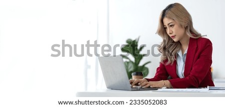 Confident Asian businesswoman While sitting at desk with laptop and doing paperwork preparing for meeting and discussing at office. startup business ideas accounting finance panorama, banner