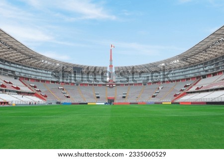 National stadium in Lima, Peru. Peruvian soccer stadium in Lima. Stadium for musical concerts and soccer. Empty stadium during the day, with a Peruvian flag. Royalty-Free Stock Photo #2335060529