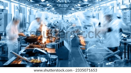 Motion chefs working in Chinese restaurant kitchen Royalty-Free Stock Photo #2335071653