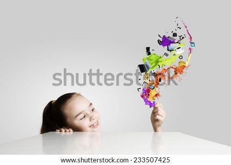 Little cute girl and colorful paint splashes