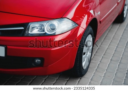 Stylish, modern bright red family car. Xenon headlights.