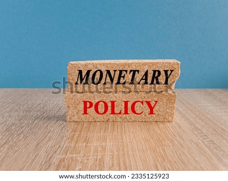 Concept red words Monetary Policy on brick blocks. Ideas for Increase or Decrease interest rates, Stimulate the economy, Moneyless valuable Royalty-Free Stock Photo #2335125923