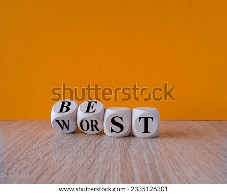 Best or worst symbol. Turned wooden cubes and changes the word best to worst. Beautiful wooden table, yellow background, copy space. Business and best or worst concept.