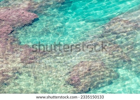 Turquoise water of the sea as an abstract background. View from above.