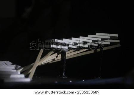 Side view of white architectural model with black background. Studio exploration model based on stacking made from PVC board. Closeup pattern
