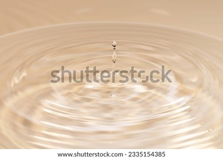 Water drops falling on water surface Royalty-Free Stock Photo #2335154385