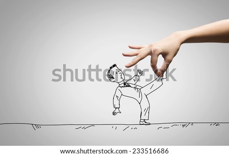 Close up of human hand catching running away businessman