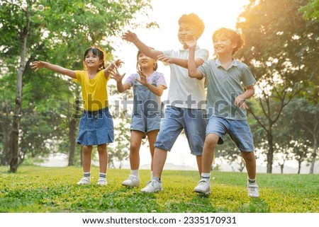 group image of cute asian children playing in the park Royalty-Free Stock Photo #2335170931