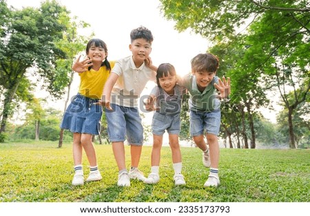 group of cute asian kids having fun in the park