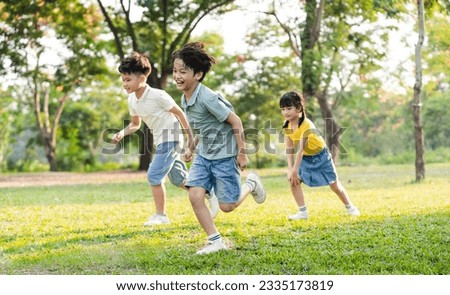 group image of asian children having fun in the park Royalty-Free Stock Photo #2335173819