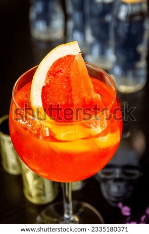 Aperol cocktail on a wooden table with decor