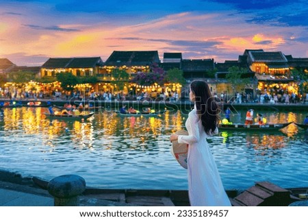 Asian woman wearing vietnam culture traditional at Hoi An ancient town,Hoi an city in Vietnam. Royalty-Free Stock Photo #2335189457