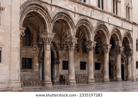 Facade of the old building of Dubrovnik with order arcade. Details of ancient architecture.
