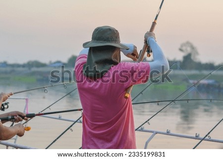 man standing fishing in the river