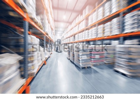 Forklift working in brewery warehouse stock industrial premises for storing kegs with beer. Concept logistics, transport. Motion blur effect, sunlight.