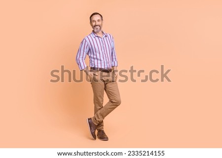 Portrait of friendly person with white gray beard dressed colorful shirt arms in pockets at office isolated on pastel color background