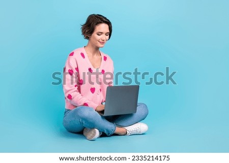 Full body photo of cute young woman bob brown hair sit floor using new apple macbook comfort workplace isolated over blue color background Royalty-Free Stock Photo #2335214175