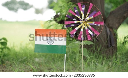 Indian tricolor flag with  paper pinwheels with nature background. Conceptual image for Indian national day celebration and events. Royalty-Free Stock Photo #2335230995
