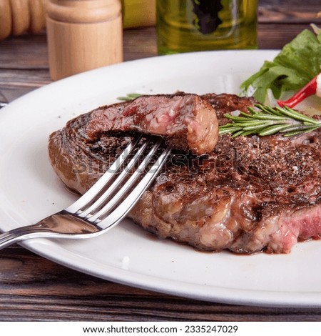 A piece of steak with salad. Close-up of slicing fillet steak