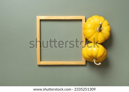 Gold frame with decorative pumpkin. Autumn minimalist aesthetic concept.