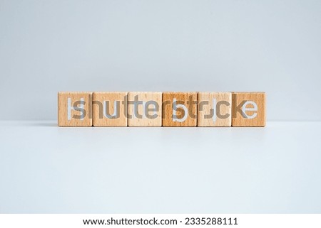 Wooden blocks form the text "Humble" against a white background. Royalty-Free Stock Photo #2335288111