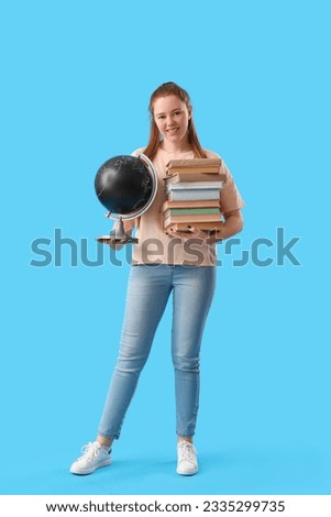 Teenage girl with books and globe on blue background