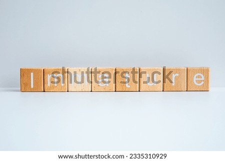 Wooden blocks form the text "Immature" against a white background.