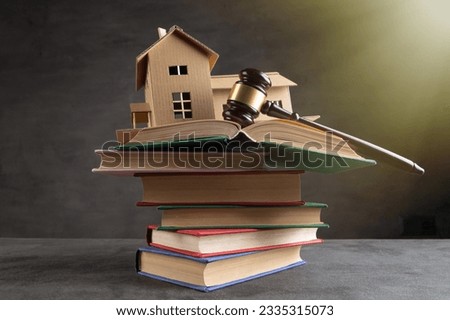 House model, gavel and books on the desk, Real property law concept