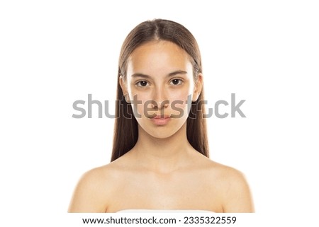 Portrait of young beautiful shurtless woman looking at camera. Studio photo isolated on white background.