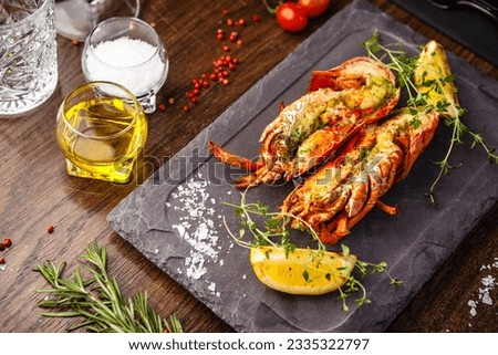 Lobster with flavored butter. Herb butter, lemon. Delicious healthy traditional food closeup served for lunch in modern gourmet cuisine restaurant Royalty-Free Stock Photo #2335322797