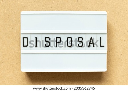 Lightbox with word disposal on wood background