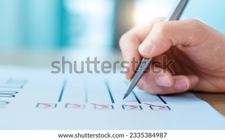 Hand holding pen planning To Do List Royalty-Free Stock Photo #2335384987