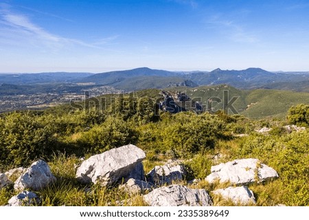 Landscape from the Ranc de Banes, near Sumene in the south of the Cevennes, on the Pic d'Anjeau, le Rochers de la Tude and, in the foreground, on the cliffs of the Combe Chaude Regional Nature Reserve Royalty-Free Stock Photo #2335389649