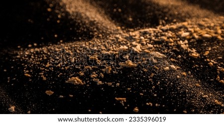 Abstract image made with flour and breadcrumbs on dark background. Conceptual image, alluding to space and cosmos, the unknown, light and darkness.