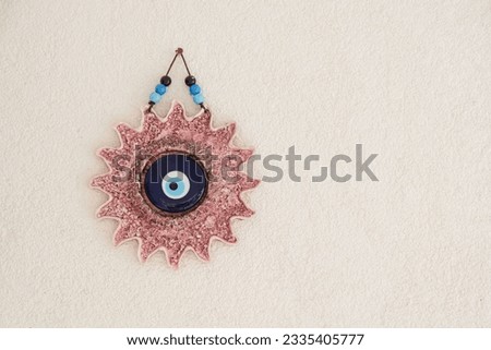 Blue Beads evil eye beads hanging on the old Gothic style concrete stone wall, gift object Tourism travel trip holiday, Eastern culture of amulets