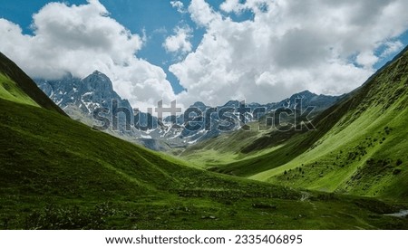 Mountain landscape with a view of the valley and Mount Chaukhi. Juta georgia, beautiful sky and rock