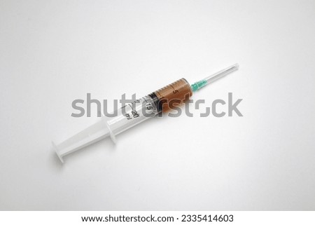 Injection syringe with needle full of inflammatory acid infection detected up for analysis after breast surgery during x-ray to remove cyst caused by hormonal imbalance in the body