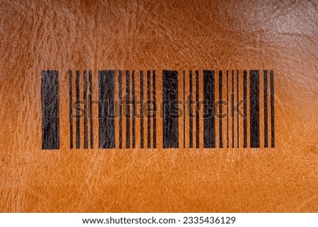 Fake barcode linesdrawn with black ink on genuine leather texture, abstract pattern close up