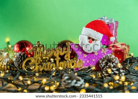 Banner with Christmas details and decorations on a green background, including ornaments, Santa Claus, gifts, boxes, lights, and letters spelling "Merry Christmas." Concept of Christmas celebration. 