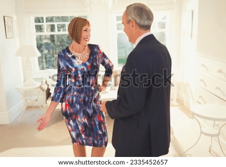 Well-dressed mature woman posing for husband Royalty-Free Stock Photo #2335452657