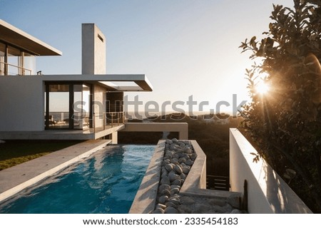 Modern house overlooking beach at sunset Royalty-Free Stock Photo #2335454183