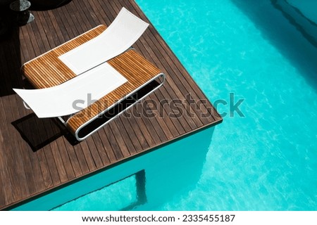 Lounge chairs at luxury poolside