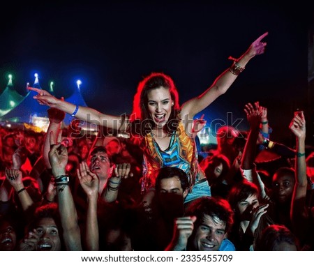 Cheering woman on man shoulders at music festival Royalty-Free Stock Photo #2335455709