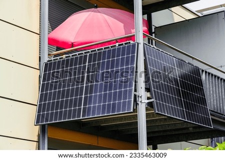 Balcony Small Solar Panel energy system. Mini photovoltaic power plant. Solar battery on balcony wall of modern house in Germany.  Mini PV plants generate your own electricity plug play. Royalty-Free Stock Photo #2335463009